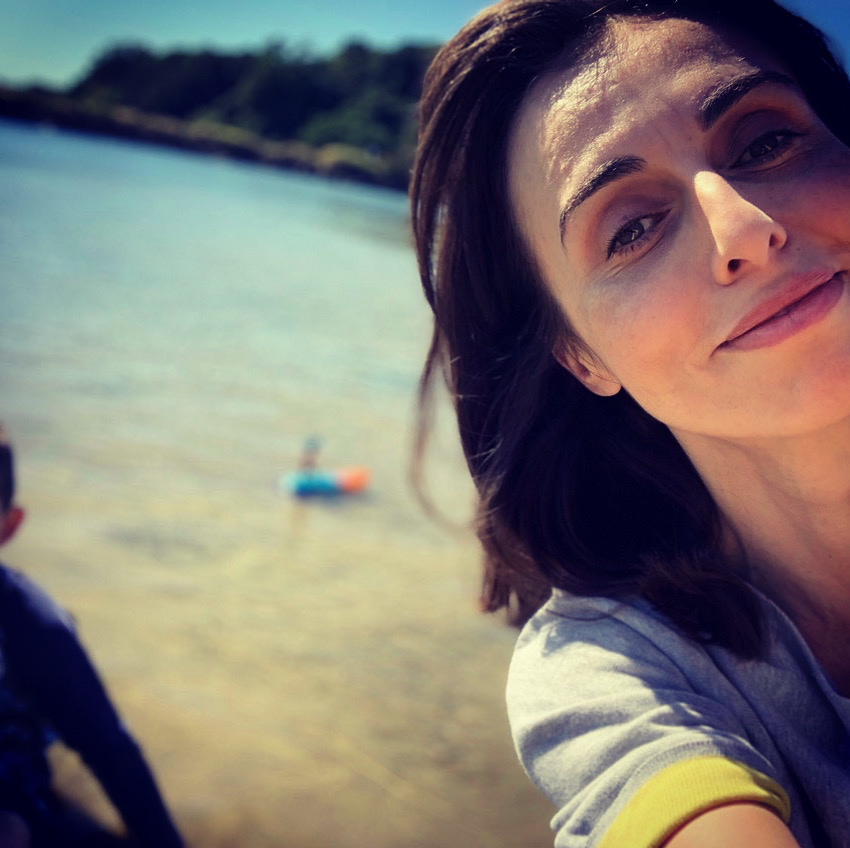 Photo of researcher, out of focus beach background.